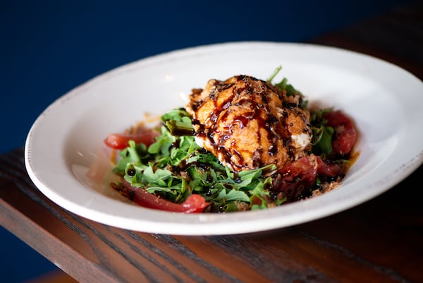 The Lost Druid Fried Burrata Salad, with peach jam, balsamic glaze, prosciutto, pickled tomato, and arugula.