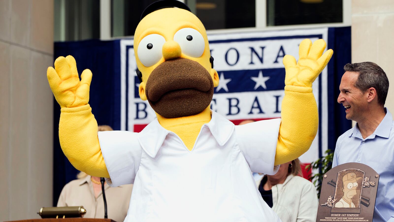 An actor portraying cartoon character Homer Simpson reacts as the character receives a plaque from the National Baseball Hall of Fame in Cooperstown, N.Y., on Saturday, May 27, 2017.