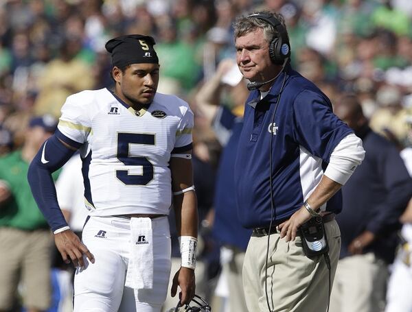 Georgia Tech head coach Paul Johnson talks with quarterback Justin Thomas (5) during the first half of an NCAA college football game against Notre Dame in South Bend, Ind., Saturday, Sept. 19, 2015. (AP Photo/Michael Conroy)