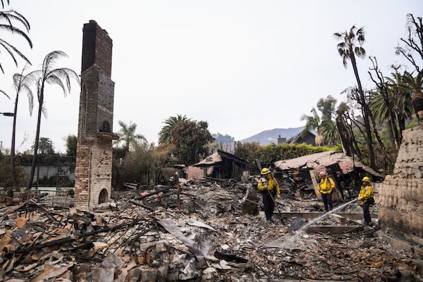 Firefighters work at a home devastated by the Franklin Fire in Malibu, Calif., Wednesday, Dec. 11, 2024. (AP Photo/Jae C. Hong)