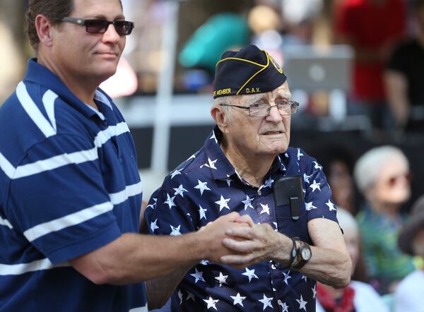 Frank Duffy, left, helps his friend Francis Turner stand during a tribute to the Army during the 2016 Roswell Remembers Memorial Day celebration .Turner was a technical sergeant in Patton's Third Army. The largest Memorial Day ceremony in the state will take place again this Monday. Ben Gray / bgray@ajc.com