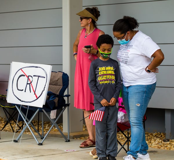 Waiting for his turn to speak, upcoming 6th grader Alex Judge III, is consoled by his mother Laura Judge, right, after he was verbally attacked by adults protesting critical race theory before a Cobb County of Education board meeting begins. Teachers, parents and local residents gather to voice their opinions on critical race theory and what Cobb County teaches and the reviews initiated by the school board Thursday, June 10, 2021. (Jenni Girtman for The Atlanta Journal Constitution)