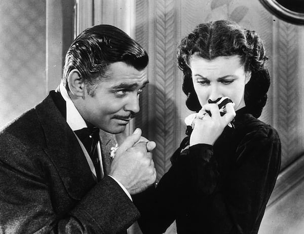 American actor Clark Gable (1901 - 1960) in his role as Rhett Butler kissing the hand of a tearful Scarlett O'Hara, played by Vivien Leigh in 'Gone With The Wind'. It was the first film TCM ever aired. 