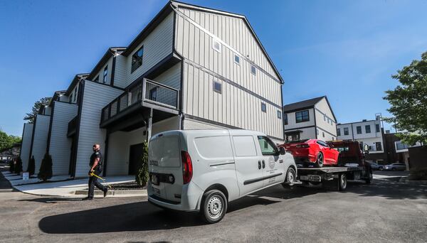 Atlanta police tow two vehicles from the scene of an April 20 homicide investigation at the One Riverside West complex located at 2030 Main Street.