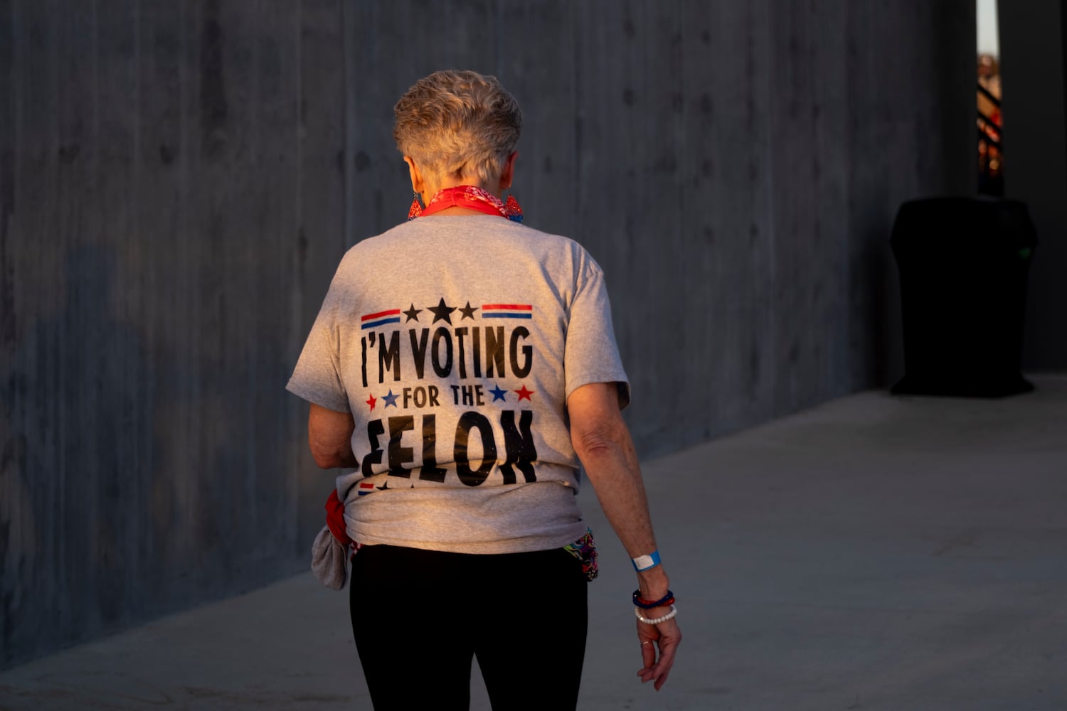 A woman heads to her seat before a rally for former President Donald Trump in Macon on Sunday, Nov. 3, 2024.   Ben Gray for the Atlanta Journal-Constitution