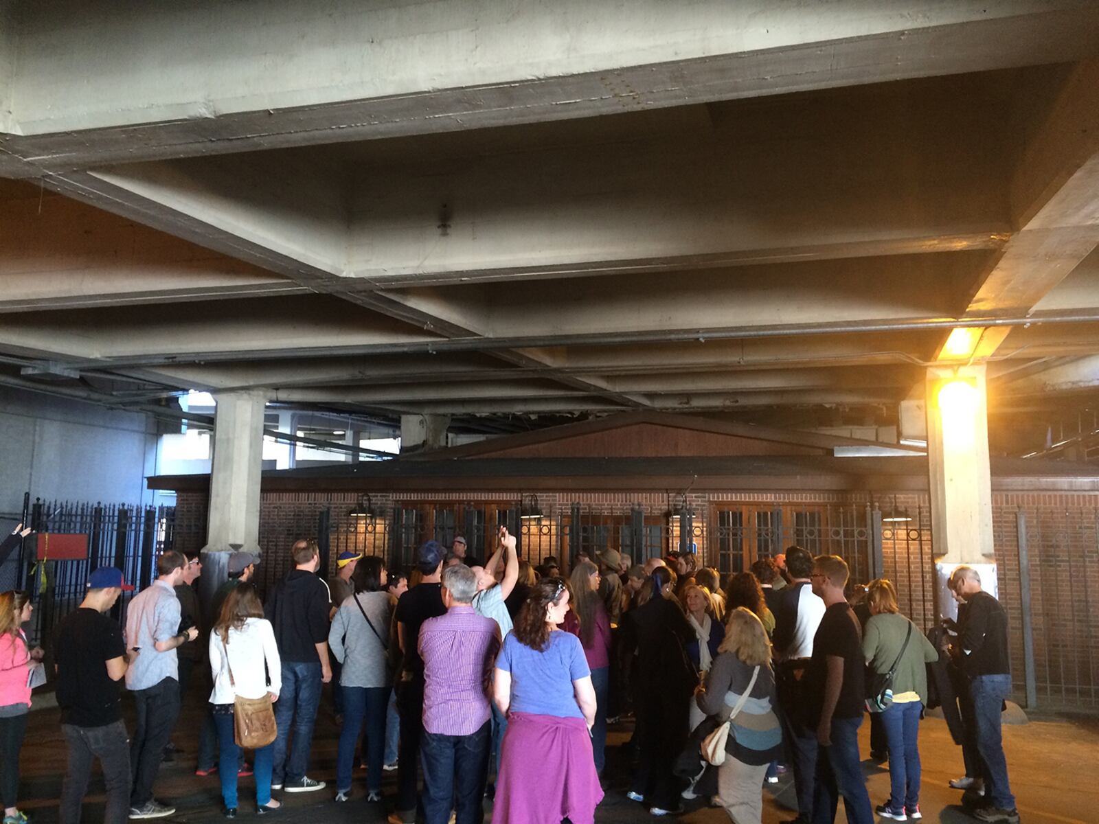 Participants on an Unseen Underground Atlanta Walking Tour take photos of the building that houses the Zero Mile Post on March 8, 2015. The state-owned building is vacant and is usually kept closed to the public, although access is sometimes granted on appointment. The building is slated for demolition sometime in 2018 or early 2019. (PETE CORSON / pcorson@ajc.com)