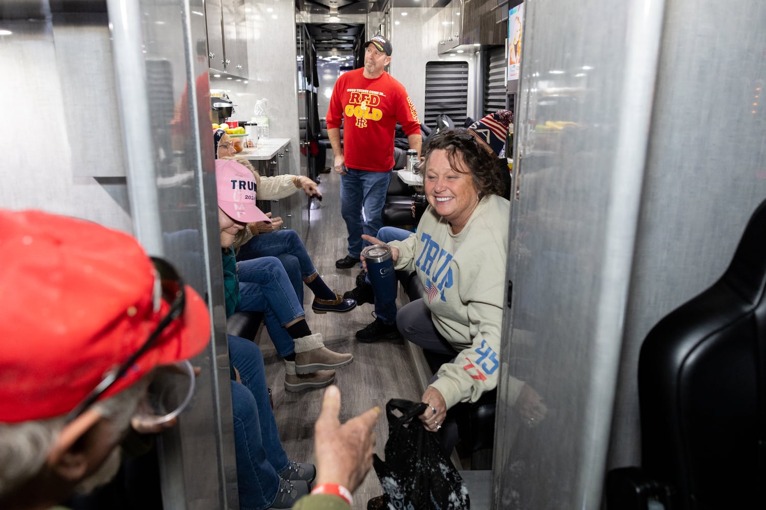 Members of a bus convoy from Georgia watch a Trump Rally live on Fox News at an RV park in College Park, Maryland on Sunday, January 19, 2025, one day before Donald Trump’s inauguration. (Arvin Temkar / AJC)