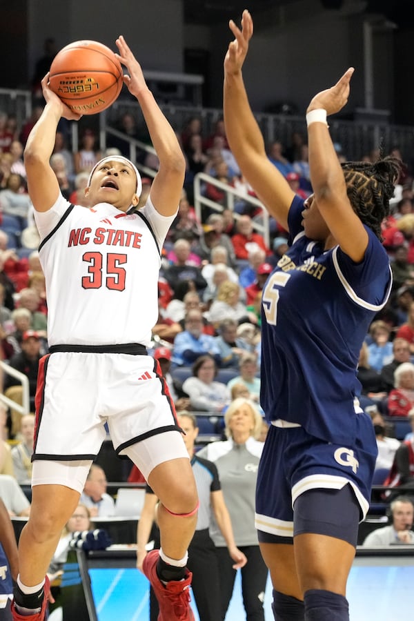 North Carolina State guard Zoe Brooks (35) shoots against Georgia Tech guard Tonie Morgan (5) during an NCAA college basketball game in the quarterfinals of the Atlantic Coast Conference tournament Greensboro, N.C., Friday, March 7, 2025. (AP Photo/Chuck Burton)