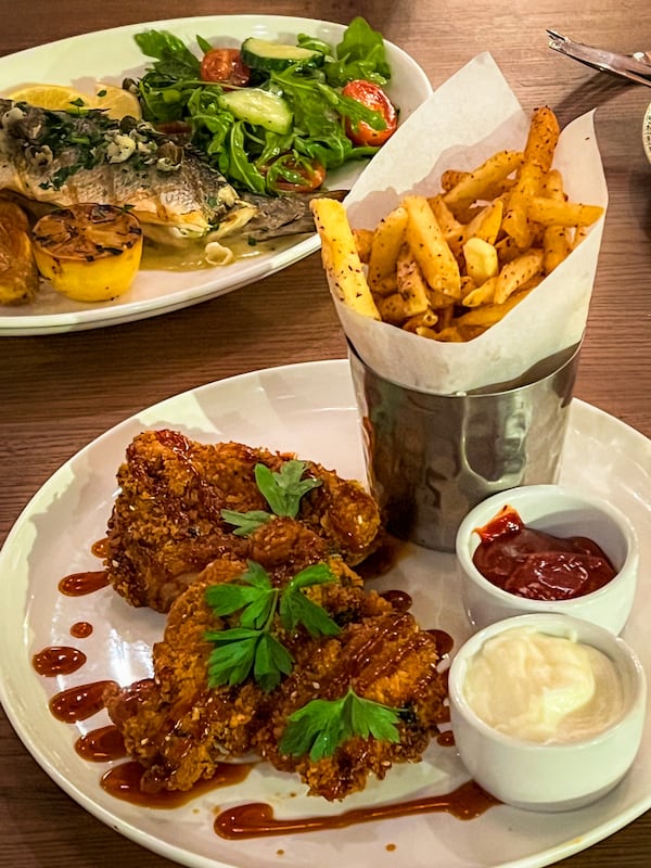 The fried chicken at Bey Mediterranean Kitchen & Bar is a wonder of flavor and texture, thanks to its thick, heavily spiced breading. (Henri Hollis/henri.hollis@ajc.com)