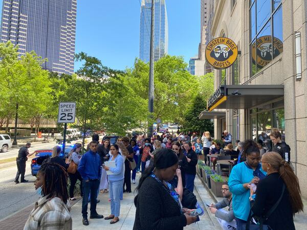 Large crowds of people were seen evacuating to the Marriott hotel on 14th Street after a shooting that injured four people and killed one at the Northside Hospital Midtown medical office building nearby.