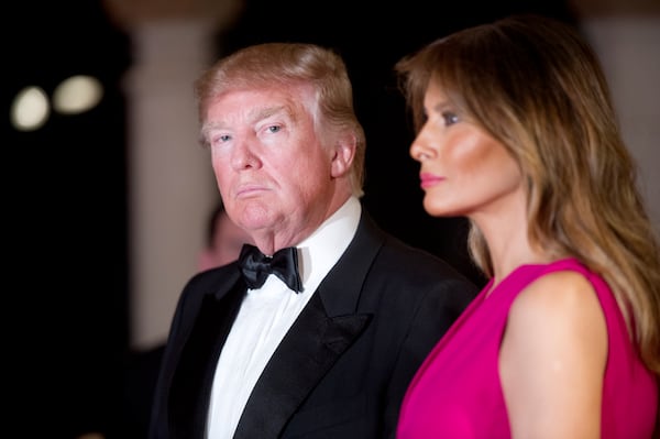 President Donald Trump and Melania Trump arrive at the Diamond Centennial Red Cross Ball at Mar-a-Lago Club Saturday.