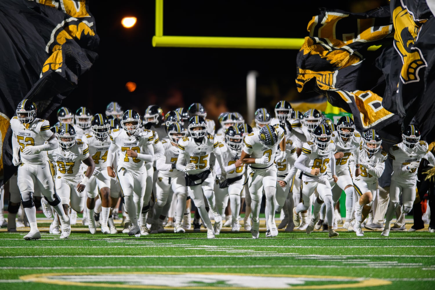 Carrollton enters the field to face Buford. (Jamie Spaar for the Atlanta Journal Constitution)