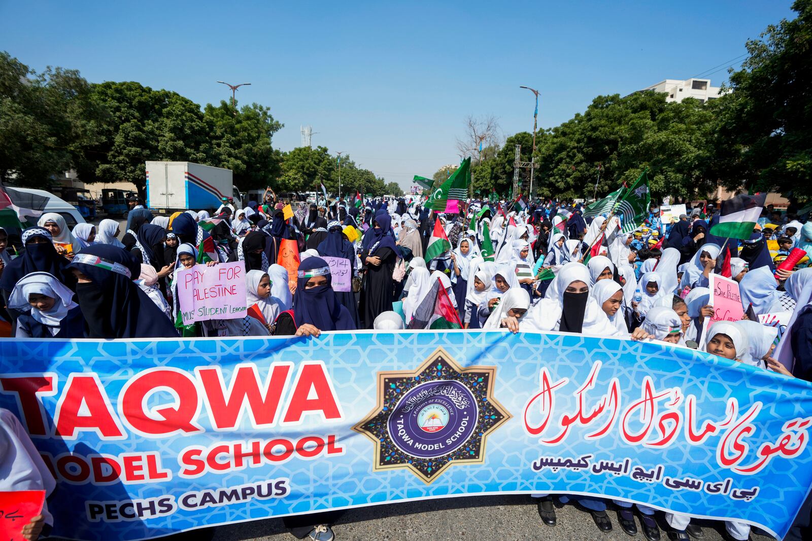 School children take part in a rally organized by Pakistan Markazi Muslim League party, to protest against Israeli airstrikes and to show solidarity with Palestinian people living in Gaza and Lebanon, in Karachi, Pakistan, Monday, Oct. 7, 2024. (AP Photo/Fareed Khan)