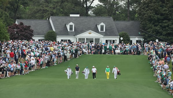 Chris Kirk, Ryan Fox, Sergio Garcia walk down the fairway of the first hole, with Butler Cabin in background, at the 2024 Masters Tournament at Augusta National Golf Club, Thursday, April 11, 2024, in Augusta, Ga. Jason Getz / Jason.Getz@ajc.com)
