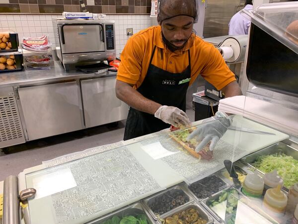 Dominick Ebwele, a deli worker at the Shamrock Plaza Publix near Decatur, makes a roast beef Pub sub according to a customer’s instructions. Pub subs are one of the things about the South that Brigid Choi misses now that she’s in Seattle. CONTRIBUTED BY OLIVIA KING