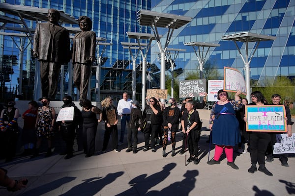 Protestors hold signs during a rally for a nationwide economic blackout Wednesday, Feb. 26, 2025, in Las Vegas. (AP Photo/John Locher)