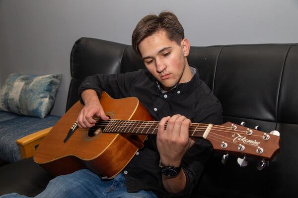 Jackson Warren practices on his father's guitar at the Music Authority in Cumming. PHIL SKINNER FOR THE ATLANTA JOURNAL-CONSTITUTION.