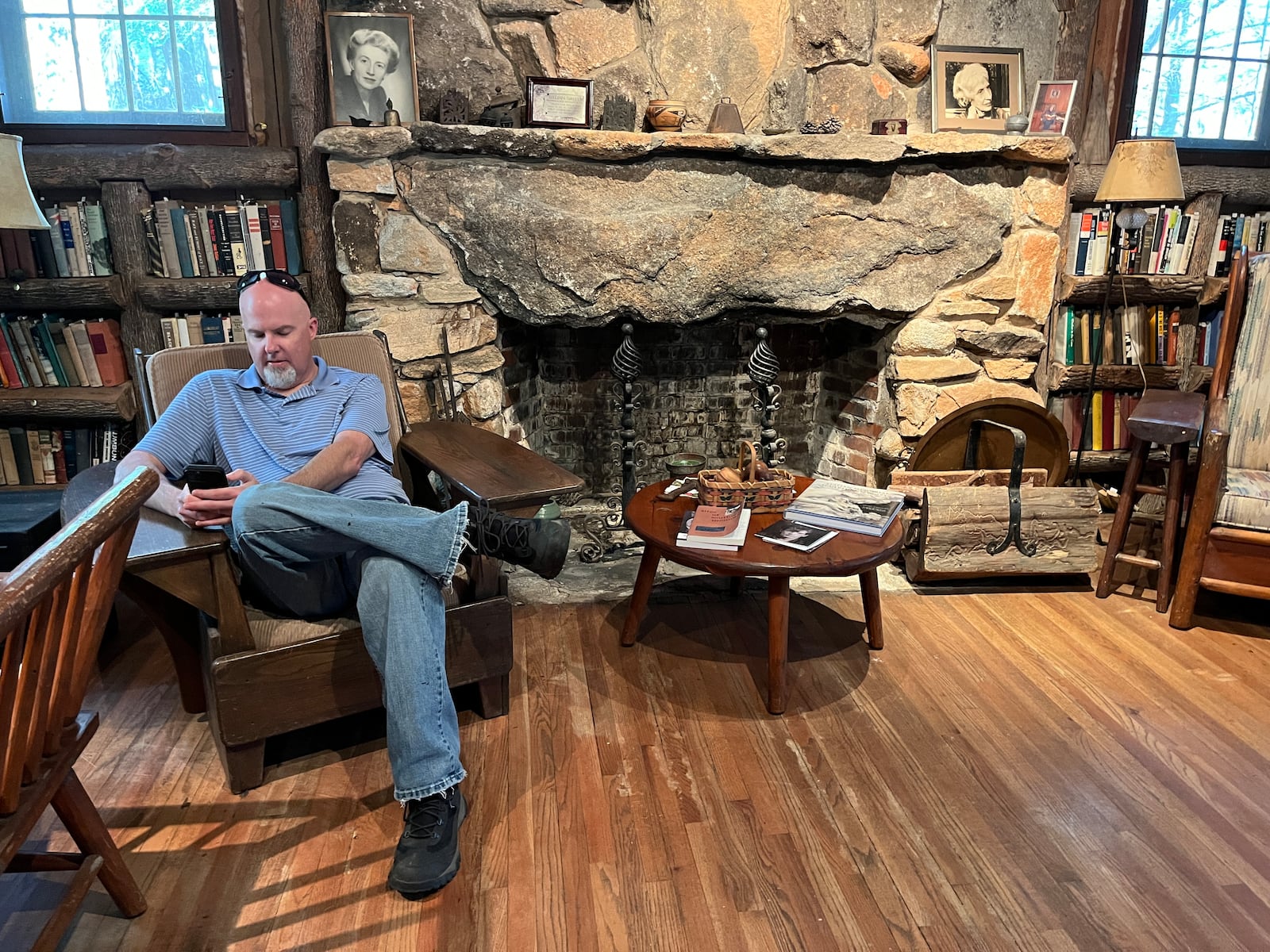 Matthew Teutsch, director of the Lillian E. Smith Center at Piedmont University, checks his email in Smith's former cottage,  where the bookshelves are filled with volumes by Freud, Schopenhauer, Spinoza and Kant. Photo: Bo Emerson