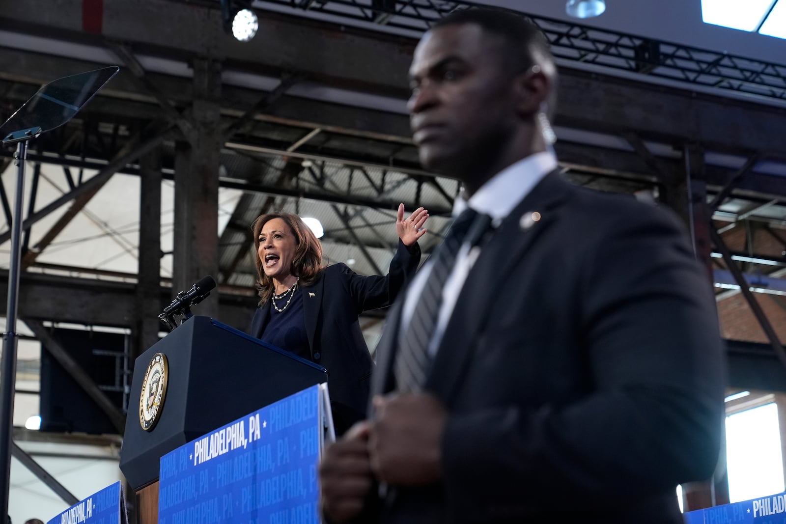 A member of the Secret Service looks on as Democratic presidential nominee Vice President Kamala Harris speaks during a community rally at the Alan Horwitz "Sixth Man" Center, Sunday, Oct. 27, 2024, in Philadelphia. (AP Photo/Susan Walsh)