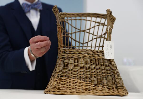 A Small chair donated by Holocaust survivor Louise Lawrence-Israels is presented by Travis Roxlau, director Collections Services, Monday, April 24, 2017, at the U.S. Holocaust Memorial Museum's, David and Fela Shapell Family Collections, Conservation and Research Center in Bowie, Md. The Shapell Center is a new state-of-the-art facility that will house the collection of record of the Holocaust. Louise Lawrence-Israels and her family went into hiding in 1942 on the top floor of an apartment in Amsterdam. She donated this small chair she played with from that time. (AP Photo/Carolyn Kaster)