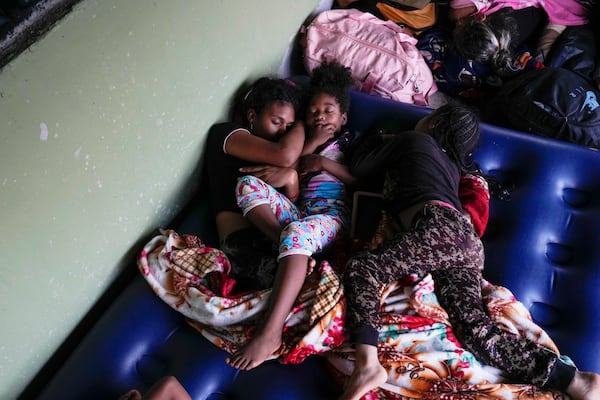 Venezuelan migrant Estebani Llerena, left, sleeps next to her daughter in Puerto Cartí, on Panama's Caribbean coast, Sunday, Feb. 23, 2025, where they plan to take a boat to Colombia after giving up hopes of reaching the U.S. while in southern Mexico amid President Trump's crackdown on migration. (AP Photo/Matias Delacroix)