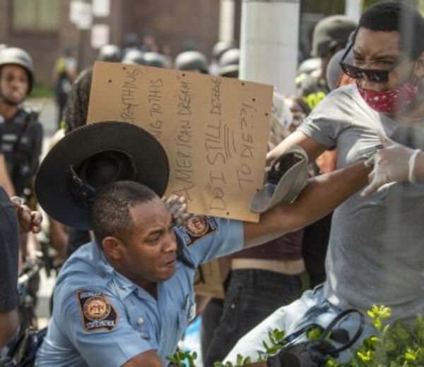 A man gets into it Monday with a Georgia State Patrol trooper after being asked to keep moving along Washington Street.