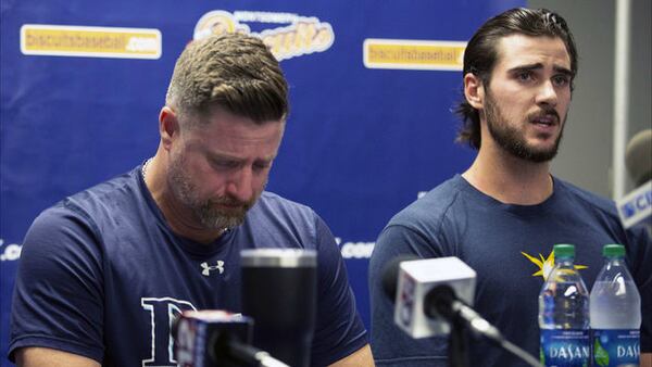 Montgomery Biscuits manager Morgan Ensberg, left, fights back tears as pitcher Ryan Thompson talks about teammate Blake Bivens Thursday, Aug. 29, 2019, in Montgomery, Ala. Bivens' wife, son and mother-in-law were killed Tuesday in a shooting.