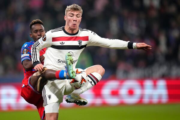 Manchester United's Rasmus Hojlund, right, challenges for the ball with Plzen's Sampson Dweh during the Europa League soccer match between Viktoria Plzen and Manchester United at the Doosan Arena in Plzen, Czech Republic, Thursday, Dec. 12, 2024. (AP Photo/Petr David Josek)