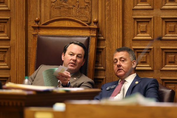 Lt. Gov. Burt Jones talks with Sen. Majority Leader Steve Gooch, R-Dahlonega, as SB 140 is discussed in the Senate Chambers during Crossover day at the State Capitol on Monday, March 6, 2023, in Atlanta. SB 140 prohibits medical professionals from giving transgender children certain hormones or surgical treatment that assists them in aligning with their gender identity. Jason Getz / Jason.Getz@ajc.com)
