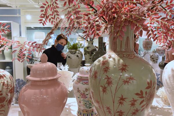 Martha Schneider, owner of La Maison in Raleigh, N.C., looks over items at Atlanta Market at AmericasMart Wednesday. Atlanta is hoping the city's events and convention business will rebound from the coronavirus, which shut down meetings for much of 2020.  (Hyosub Shin / Hyosub.Shin@ajc.com)