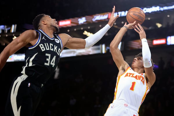 Atlanta Hawks forward Jalen Johnson (1) shoots against Milwaukee Bucks forward Giannis Antetokounmpo (34) during the first half of a semifinal game in the NBA Cup basketball tournament Saturday, Dec. 14, 2024, in Las Vegas. (AP Photo/Ian Maule)