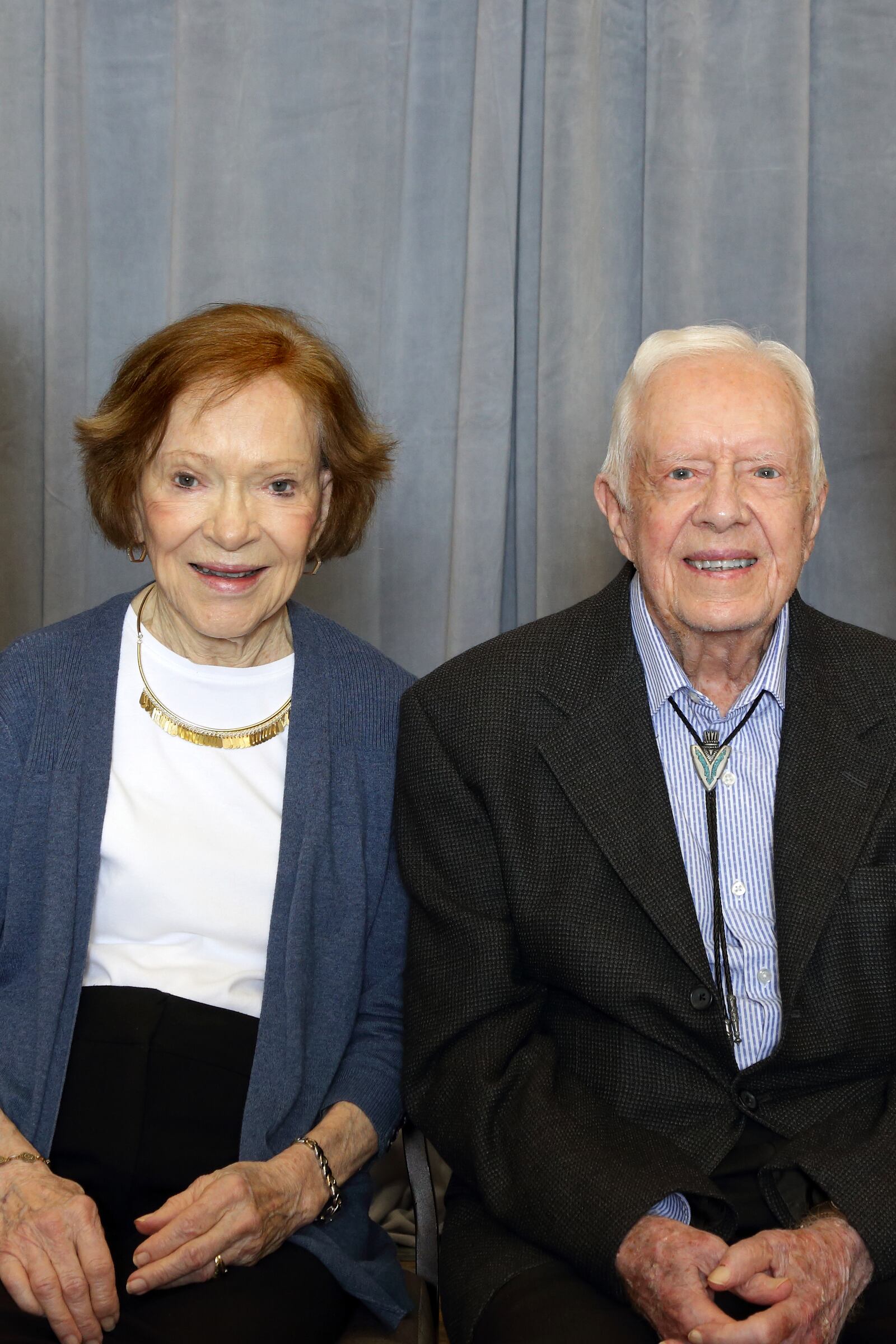 Former First Lady Rosalynn Carter and Jimmy Carter getting ready to sit down with attendees of The Carter Center Weekend, for individual photographs. 