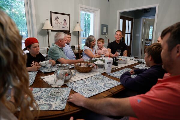 Steve and Dale Tingle hold their grandkids while Kevin Krüger smiles during a Sunday afternoon brunch in Watkinsville, Ga. Krüger, who lives in Germany, has formed a strong bond with the Tingle family after Dale Tingle donated stem cells to him, ultimately saving his life 13 years ago. (Miguel Martinez/AJC)