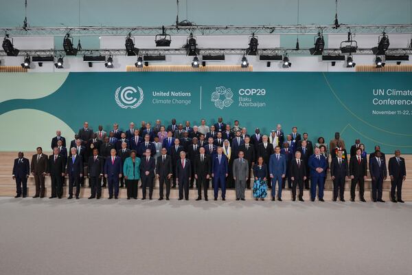 Barbados Prime Minister Mia Mottley, United Kingdom Prime Minister Keir Starmer, Simon Stiell, United Nations climate chief, Antonio Guterres, United Nations secretary-general, Ilham Aliyev, Azerbaijan president, and Turkey President Recep Tayyip, in the center, pose with others for a group photo at the COP29 U.N. Climate Summit, Tuesday, Nov. 12, 2024, in Baku, Azerbaijan. (AP Photo/Peter Dejong)