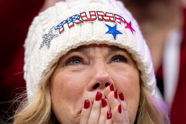 A Donald Trump supporter becomes emotional as Trump’s inauguration is played on a livestream at Capital One Arena in Washington, D.C. on Monday, January 20, 2025. (Arvin Temkar / AJC)