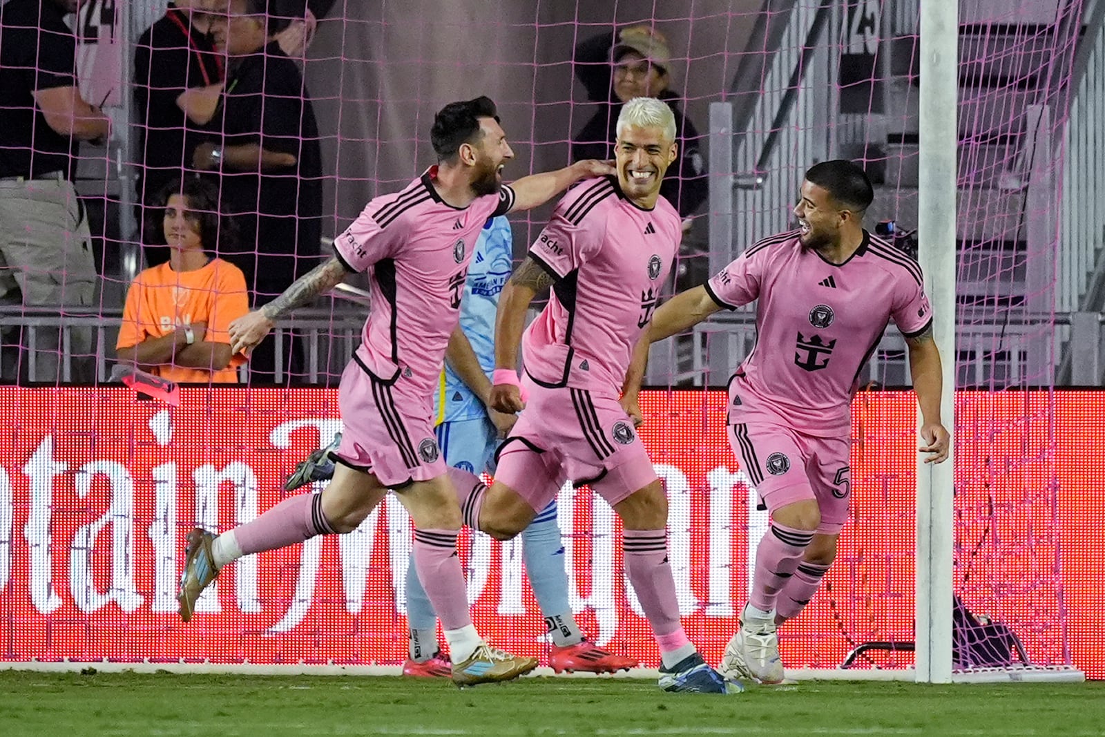 Inter Miami forward Luis Suarez (9), center, is congratulated by his teammates after scoring a goal during the first half of an MLS playoff soccer match against the Atlanta United, Friday, Oct. 25, 2024, in Fort Lauderdale, Fla. (AP Photo/Rebecca Blackwell)