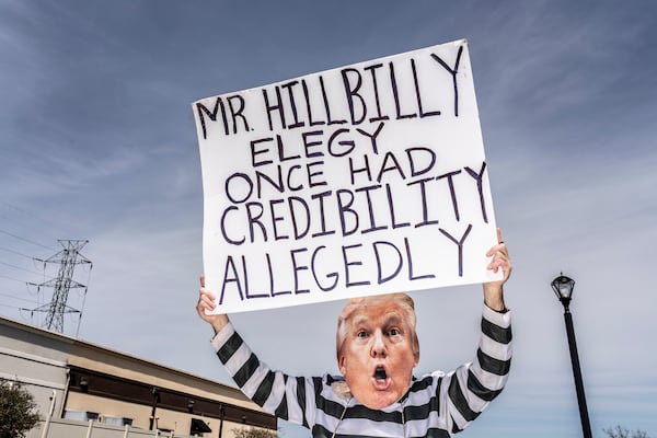 A demonstrator stands outside a campaign event held by JD Vance, then a Republican primary candidate for Ohio’s U.S. Senate seat, and former President Donald Trump in Independence, Ohio, on April 20, 2022. (Mark Peterson/The New York Times)