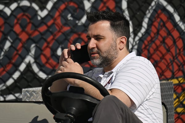 Atlanta Braves general manager Alex Anthopoulos talks on the phone during spring training workouts at CoolToday Park, Wednesday, Feb. 21, 2024, in North Port, Florida. (Hyosub Shin / Hyosub.Shin@ajc.com)