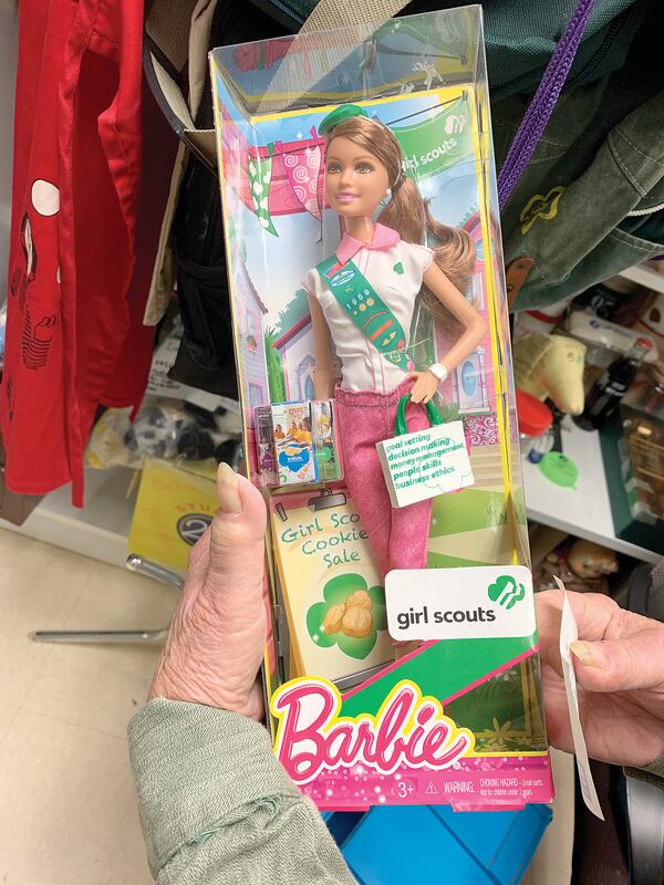 Girl Scout archivist Sue Belden displays vintage Barbie.