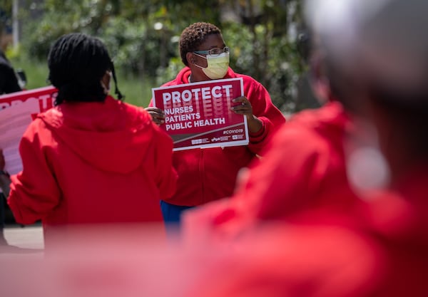 Dana Horton, a radiology registered nurse at the Atlanta VA Medical Center and the local union director for National Nurses United, is seen here protesting inadequate personal protective equipment outside the VA in April. Horton says that with COVID-19 cases ticking back up, workers are nervous again about the PPE supply.  (Ben@BenGray.com for the Atlanta Journal-Constitution)