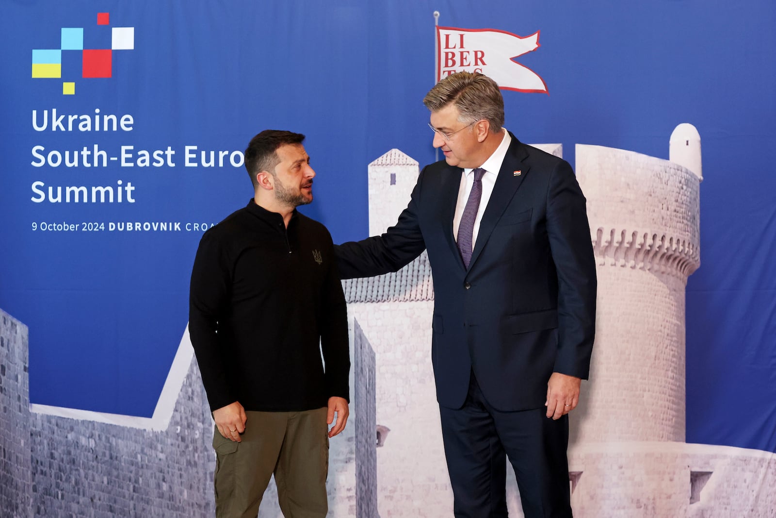 Ukrainian President Volodymyr Zelenskyy, left, is welcomed by Croatian Prime Minister Andrej Plenkovic at the Southeast Europe Croatia Ukraine summit in Dubrovnik, Croatia, Wednesday, Oct. 9, 2024. (Damir Sencar/Pool Photo via AP)