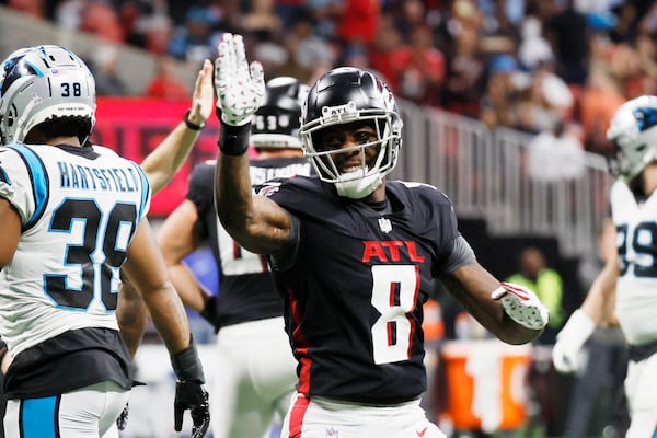 Falcons tight end Kyle Pitts runs the ball during the third quarter as wide receiver Drake London looks against the Carolina Panthers in Atlanta.
 Miguel Martinez / miguel.martinezjimenez@ajc.com