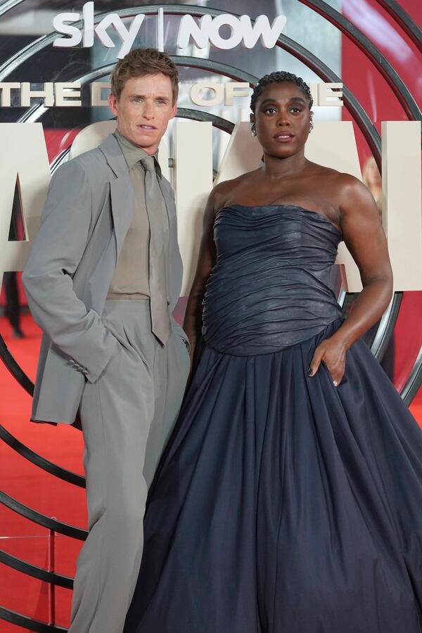 British actor Eddie Redmayne, left, and British actress Lashana Lynch pose for photos on the red carpet at the "The Day of the Jackal" premiere in London, Tuesday, Oct. 22, 2024. (AP Photo/Kin Cheung)