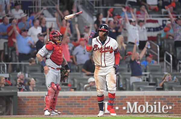 Braves center fielder Ronald Acuna Jr. flips his bat after his ninth-inning home run. (Hyosub Shin / Hyosub.Shin@ajc.com)