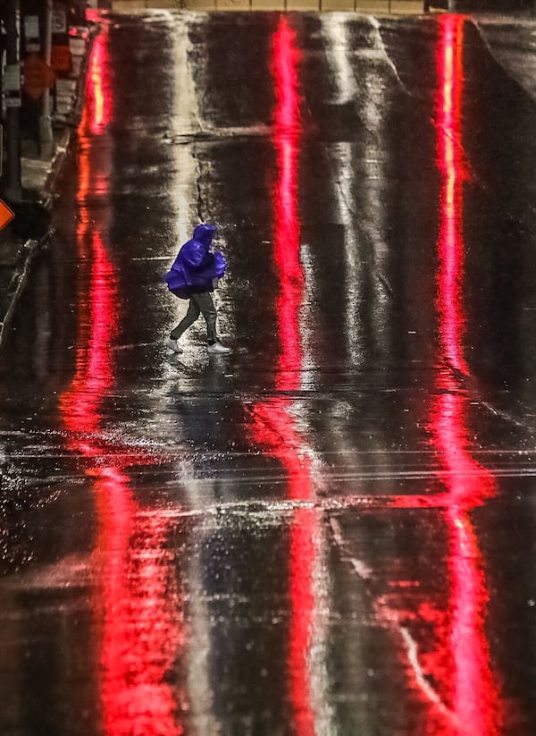 An early-morning walker braves the rain in metro Atlanta.