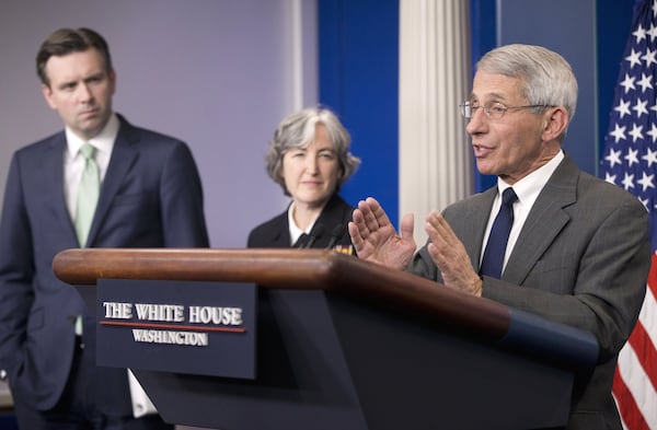 Former White House press secretary Josh Earnest (from left) and Dr. Anne Schuchat, then-principal deputy director of the CDC, listen as Dr. Anthony Fauci, then-director of NIH/NIAID, answer questions from members of the media during the daily briefing in the Brady Press Briefing Room of the White House in Washington on Monday, Feb. 8, 2016. (Pablo Martinez Monsivais/AP)