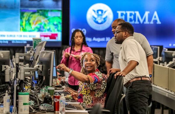 Workers in FEMA's Regional Response Coordination Center in DeKalb County on Aug. 30 prepare for Hurricane Idalia. (John Spink / John.Spink@ajc.com)

