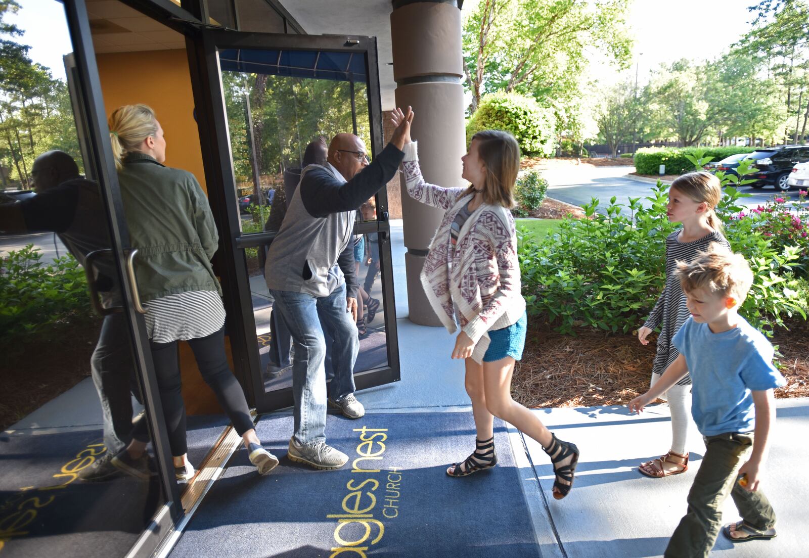 Anthony Kirk welcomes young church members before their joint service at Eagles Nest Church in Roswell on Saturday, May 6, 2017. HYOSUB SHIN / HSHIN@AJC.COM