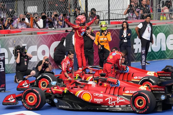 Ferrari driver Carlos Sainz of Spain celebrates after winning the Formula One Mexico Grand Prix auto race at the Hermanos Rodriguez racetrack in Mexico City, Sunday, Oct. 27, 2024. (AP Photo/Eduardo Verdugo)