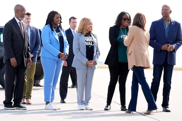 Democratic presidential nominee Vice President Kamala Harris, from second right, is greeted by Rep. Hank Johnson, D-Ga., from right, DeKalb County, Ga. Commissioner Mereda Davis Johnson, Rep. Lucy McBath, D-Ga., Nicole Hendrickson, Gwinnett County, Ga. Board of Commissioners chairwoman and former Georgia State Representative Calvin Smyre as she arrives at Hartsfield Jackson International Airport in Atlanta, Saturday, Nov. 2, 2024. (AP Photo/Jacquelyn Martin)